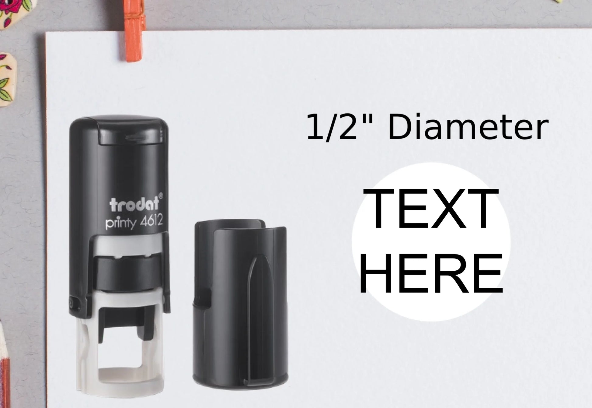 blank-white-page-with-clothes-peg-surrounded-with-stationeries-gray-background