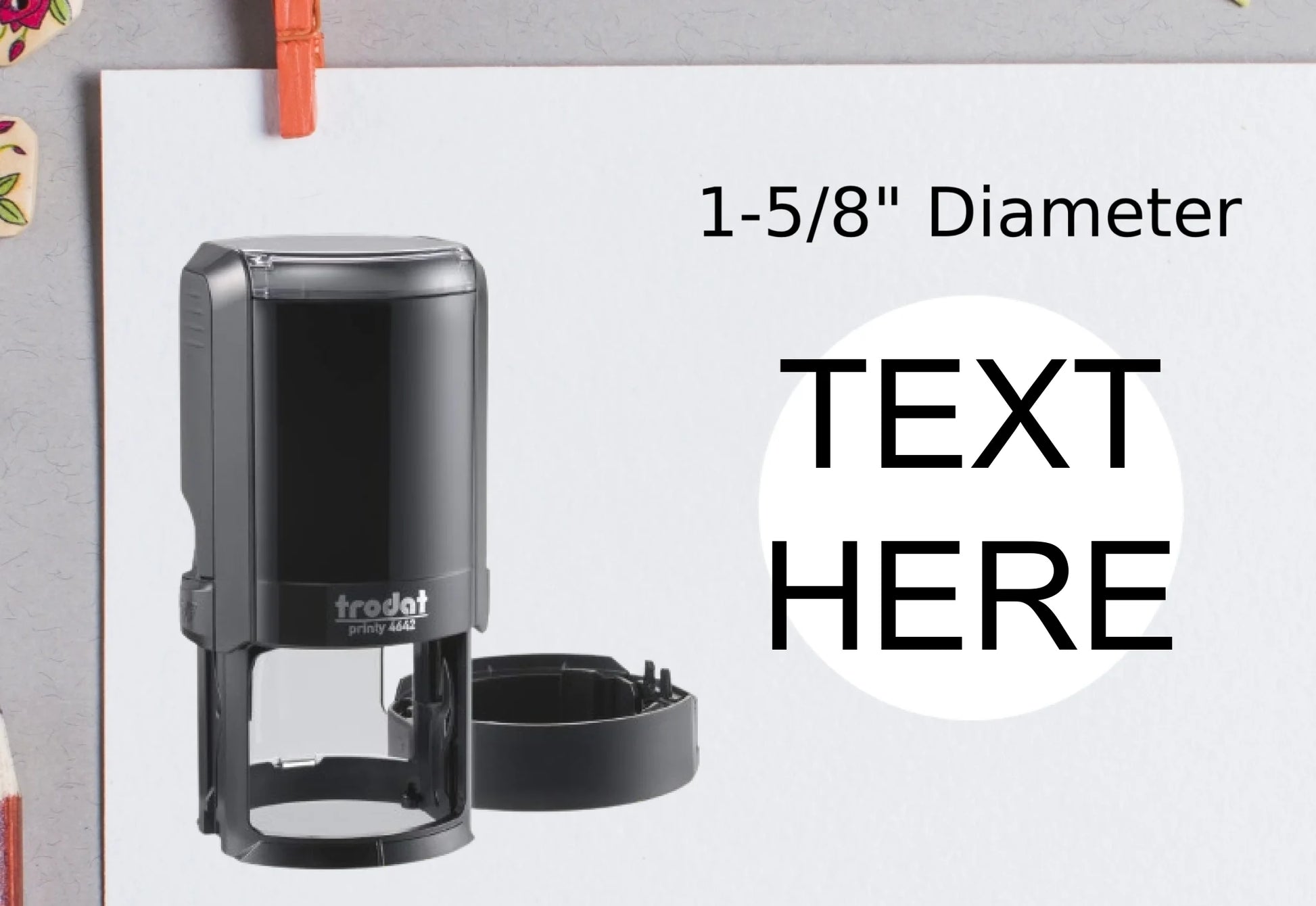 blank-white-page-with-clothes-peg-surrounded-with-stationeries-gray-background