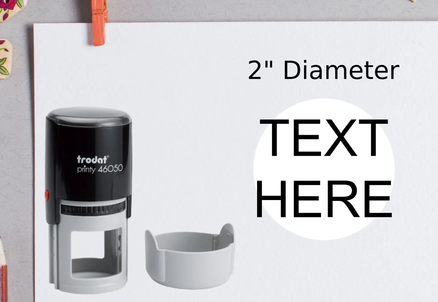 blank-white-page-with-clothes-peg-surrounded-with-stationeries-gray-background